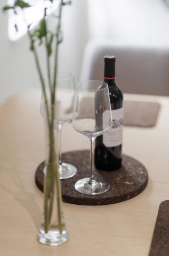 two glasses and a bottle of wine on a table at Rock Mill Retreat in Stony Middleton
