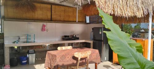 a kitchen with a table and a kitchen with a counter at Rumah Sedana Ubud Centre in Ubud