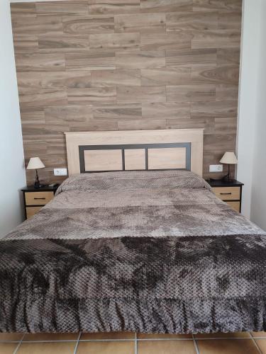 a bedroom with a large bed with two night stands at Casa Mirian in Arroyo Frio