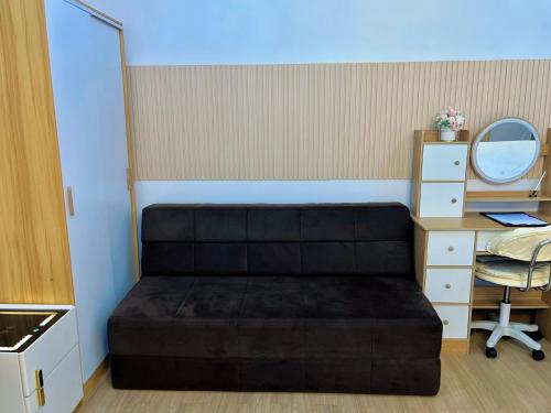 a bedroom with a bed and a desk and a mirror at Auberge Condotels B at SMDC Hope Residences in Trece Martires
