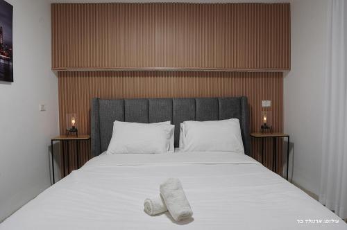 a bed with two towels laying on top of it at וילה ויליז'ן in H̱azon