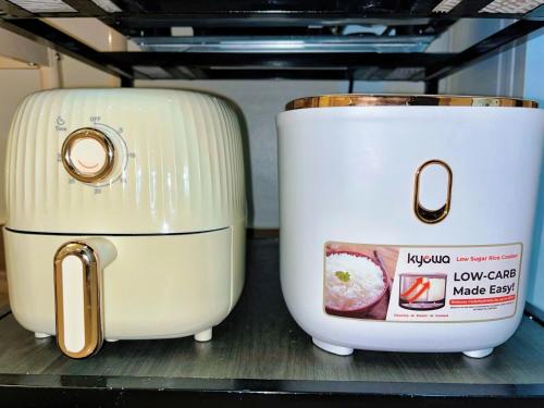 two toasters sitting on a shelf in a refrigerator at Auberge Condotels B at SMDC Hope Residences in Trece Martires