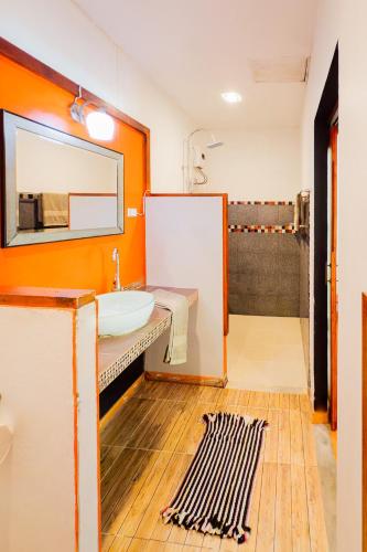 a bathroom with a sink and a mirror at Leon Oasis Nai Harn in Rawai Beach