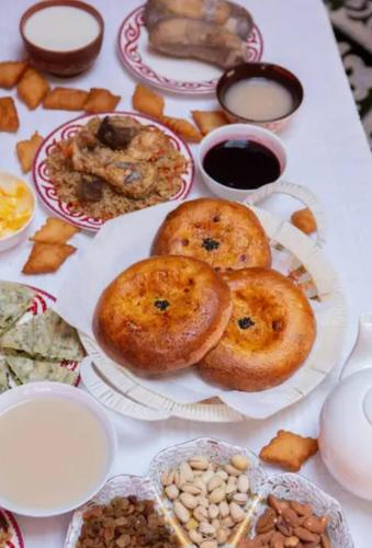 a table topped with plates of food on top at Yurt Camp Town of heavenly mountains " Kyz Zhibek" in Dzhetyoguz
