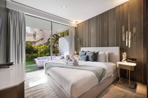 a bedroom with a large bed and a large window at FIVE Palm Jumeirah Premier Apartments in Dubai