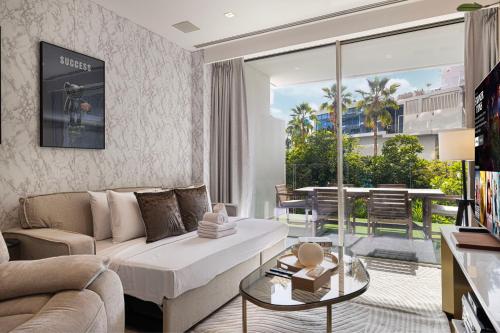 a living room with a couch and a table at FIVE Palm Jumeirah Premier Apartments in Dubai