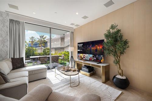 a living room with a couch and a table at FIVE Palm Jumeirah Premier Apartments in Dubai