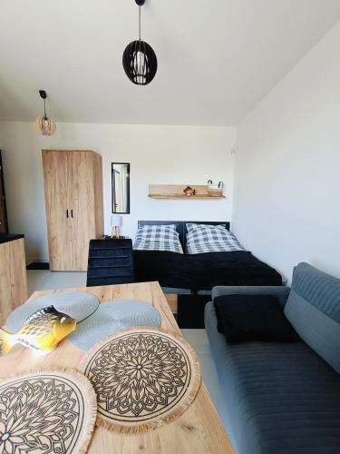 a living room with a couch and a table at Dom Gościnny Helios in Mielno