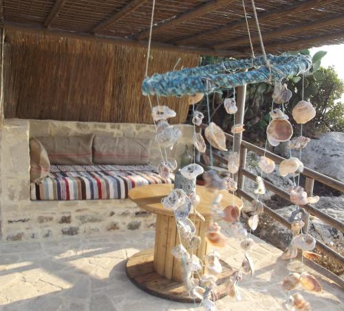a group of shells hanging from a table on a patio at Fudulis Villa in Ravdhoúkha