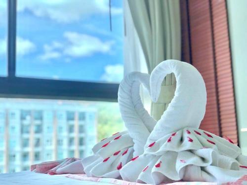 a swan made out of towels on a bed at Phu Dahla Residences in Ao Nang Beach