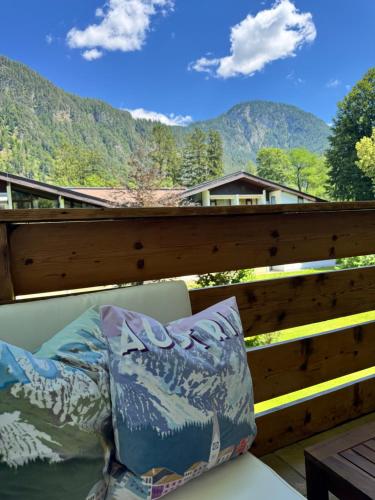 a couch on a balcony with a view of mountains at Chalet-Stil mit Pool und Bergblick in Sankt Martin bei Lofer