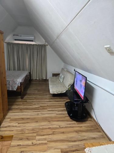 a attic room with a laptop computer on a desk at Loversnest Self Catering in Anse aux Pins