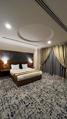 a bedroom with a large bed with a large rug at فخامة الشرق للشقق المخدومة in Al Khobar