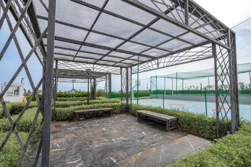 a metal pavilion with benches and a pool at Garden Bay Signature AppartHotel in Casablanca