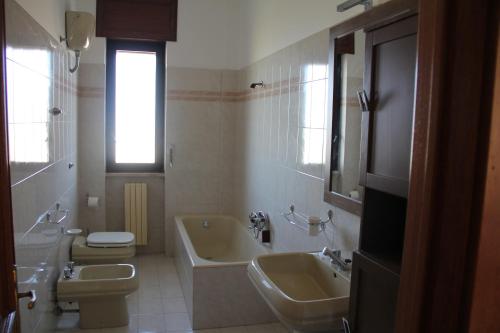 トリカーゼにあるCasa Pellaiのバスルーム(洗面台2台、バスタブ、トイレ付)