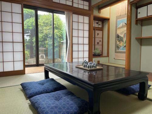 a living room with a table and a couch at 墨松居 in Osaka