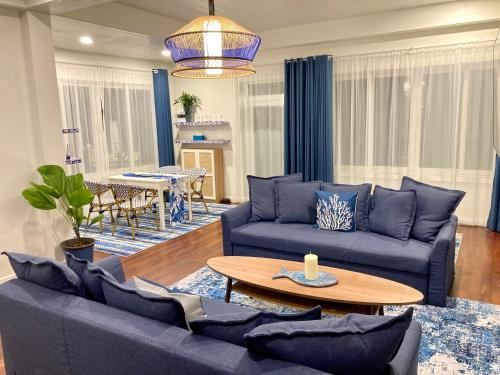 a living room with blue couches and a table at Love at First Sight in Chumphon
