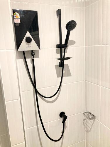 a shower with a shower head in a bathroom at Love at First Sight in Chumphon