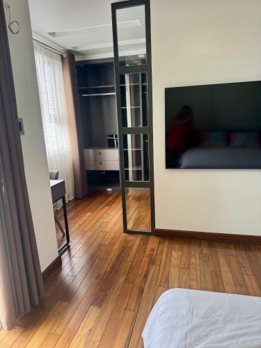a bedroom with a mirror and a bed in a room at SHP Plaza Khanh Phong Homestay in Hai Phong