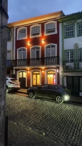 a black car parked in front of a building at Cristal apartamento 1 esq Monte Brasil in Angra do Heroísmo