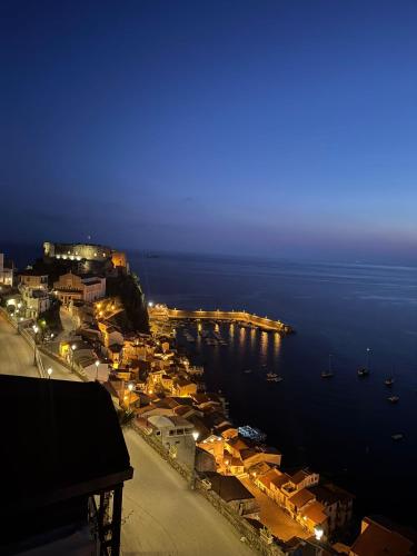 a view of a town with a harbor at night at Casa Vacanze Belvedere in Scilla