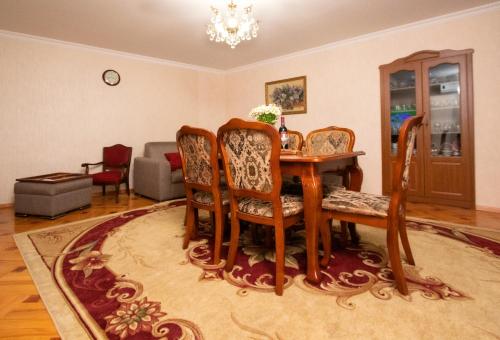 a living room with a wooden table and chairs at Cozy House And Yard Old Tbilisi Center in Tbilisi City
