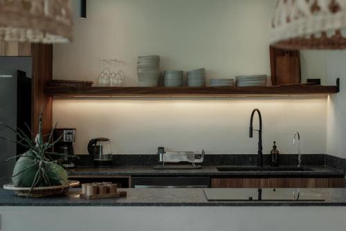 a kitchen with a sink and a counter top at Ka'ana Condo in Tulum