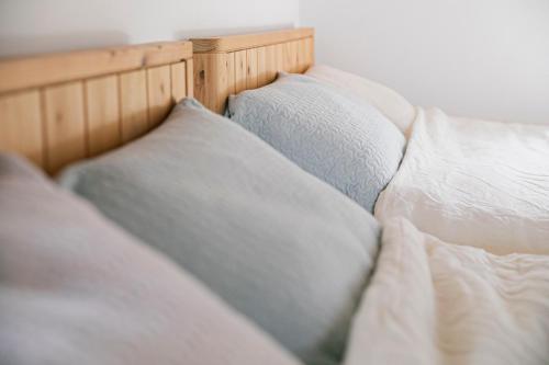 a close up of a bed with white pillows at Villa Classico Itoshima in Itoshima