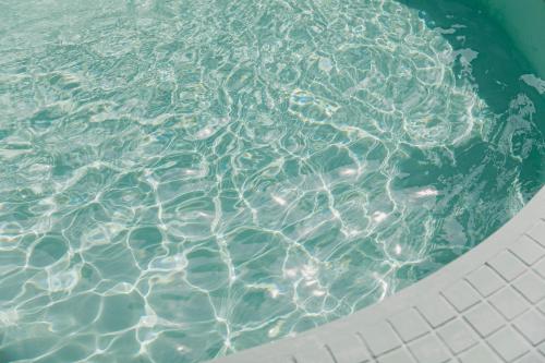 a pool of water with ripples in it at Villa Classico Itoshima in Itoshima