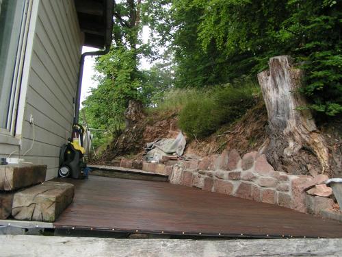 a porch of a house with a wooden deck at Wellness und Wander Oase Burgwald 