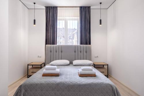 a bedroom with two beds with pillows on it at Villa Nikoletta SPA in Bukovel