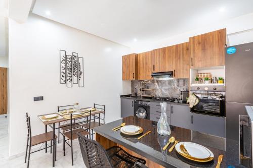a kitchen with a table and a stove top oven at Cocoon in Gueliz, Netflix, IPTV in Marrakech