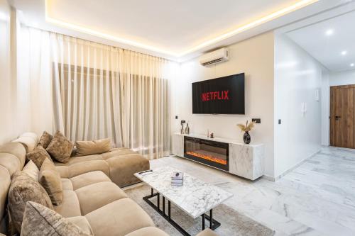 a living room with a couch and a fireplace at Cocoon in Gueliz, Netflix, IPTV in Marrakech