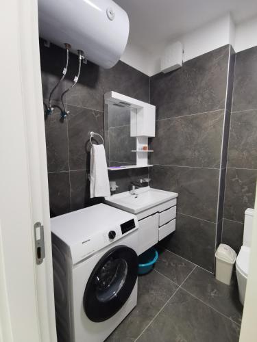 a bathroom with a sink and a toilet at SeaBreeze Apartments in Golem
