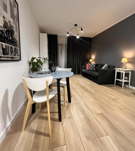 a living room with a table and a couch at Nice Studio by the River Walonska 15 SPA - GYM - SAUNA - JACUZZI in Wrocław