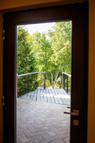 a door leading to a patio with trees behind it at Große Wohnung mit Loggia in Templin