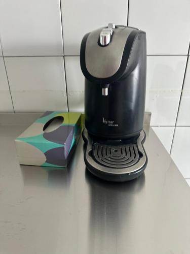 a coffee maker sitting on a counter next to a box at Cozy 2BR Apt AxisAtrium Mall wPool Pandan Indah Ampang Kuala Lumpur in Ampang