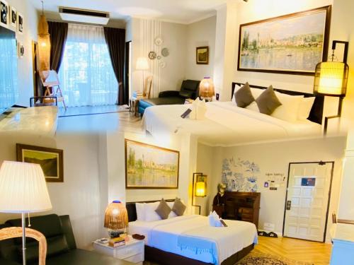 two pictures of a hotel room with two beds at Yuu Hotel Ubon Ratchathani in Ubon Ratchathani