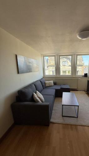 a living room with a couch and a table at La douce Parenthèse in Namur