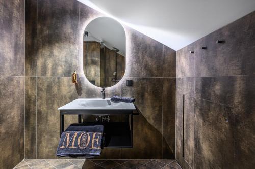 a bathroom with a sink and a mirror at Hotell Moe 