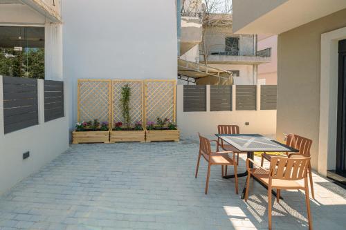 a patio with a table and chairs in a building at Modern house Katoikia Pyrgos in Pýrgos