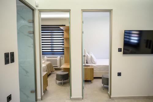 a room with a mirror and a bedroom with a bed at Modern house Katoikia Pyrgos in Pýrgos