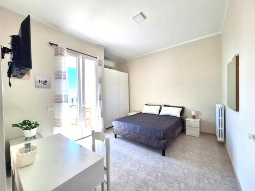 a bedroom with a bed and a table and a window at Casa Dolce Casa in Termoli