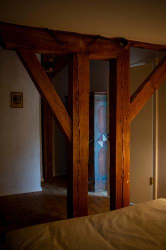 a bedroom with a wooden frame and a bed at Große Wohnung mit Loggia in Templin
