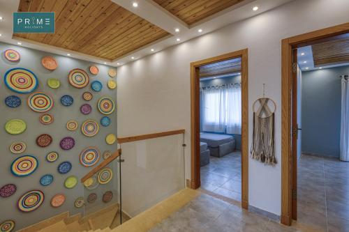 a hallway with a wall covered in colorful stones at Prime Holidays Mountain View Ras ElHekma in Ras Elhekma