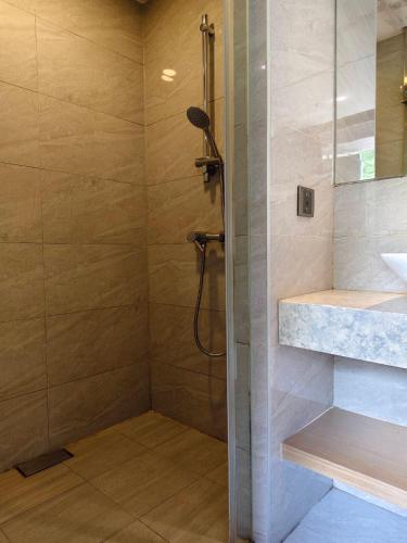 a bathroom with a shower and a sink at CHECK inn SELECT Taipei NeiHu in Taipei