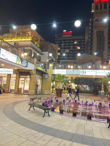 a shopping mall with a display of purple flowers at LuxePink Teddd Jucuzzi Studio-PrivatePatio in Gurgaon