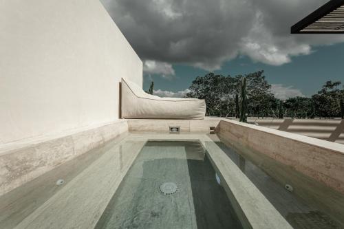 a swimming pool in the middle of a building at Ka'ana Condo in Tulum