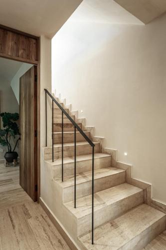 a staircase in a house with a stair railing at Ka'ana Condo in Tulum