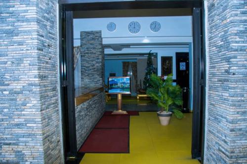a hallway of a building with a clock on the wall at Zoey International Hotels Ltd in Owerri